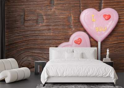 Lollipops heart on vintage wooden background Wall mural