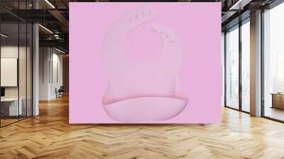 Pink silicone bib on pink background Wall mural