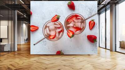 Two strawberry cocktails with ice on a light background with berries Wall mural