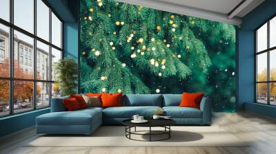 Branch of green Christmas tree on background of falling snow and new year's lights Wall mural