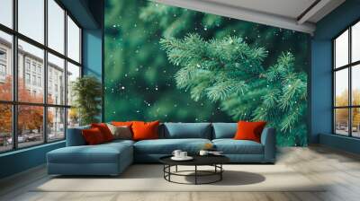 Green branch of Christmas tree on background of falling snow Wall mural