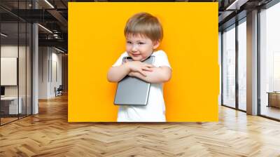 happy cute boy hugging his lovely tablet computer pc, Z generation, children who was born with technology Wall mural