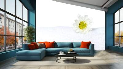 Beautiful flower on white towel and stones on the bamboo mat. Wall mural