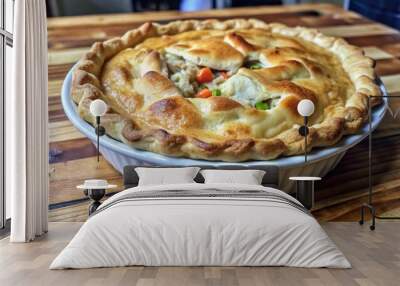 Delicious homemade chicken pot pie with flaky crust and colorful vegetables served fresh from the oven on a wooden table Wall mural