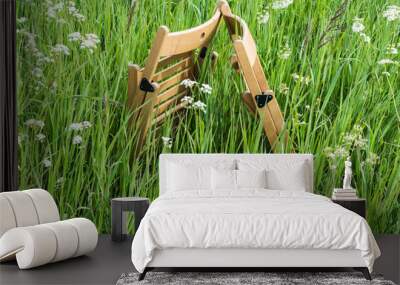 Chairs for relaxation on a green meadow Wall mural