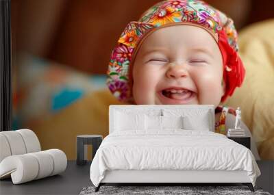 Close-up of an adorable baby with a bright smile, wearing a colorful floral hat Wall mural