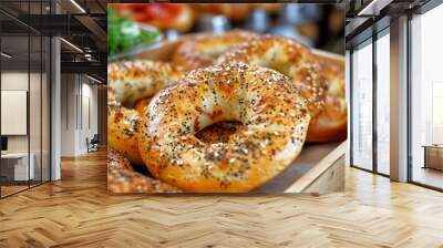 Close-up of delicious homemade bagels garnished with poppy and sesame seeds on a wooden tray Wall mural