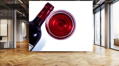 A glass and a bottle of red wine on a white background. View from above. Wall mural