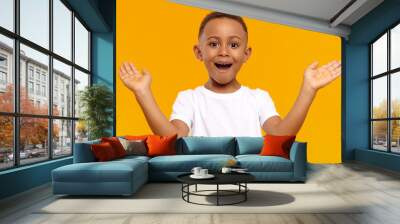 I’m so happy. Picture of overjoyed excited black little boy of African origin exclaiming emotionally and gesturing actively with both hands, amazed with good news, receiving highest mark for test Wall mural