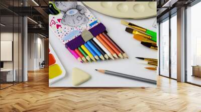 A set of colored pencils and a set of colored paints for children's creativity. Wall mural