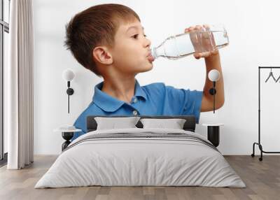 Boy drinks water from bottle isolated on white background Wall mural