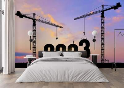 Vector silhouette of construction worker with crane and sky for preparation of welcome 2023 New Year party and change new business. Businessman engineer looking 2023 blueprint in a building site. Wall mural