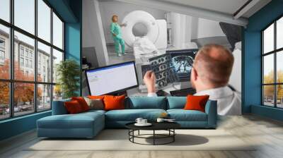 Medical computed tomography or MRI scanner. Back view of male doctor sitting at computer, nurse making MRI. Focus on nurse. Specialists working in hospital, studying results, examining. Wall mural