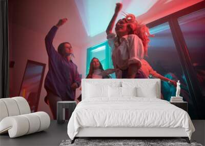 Young women having party inside contemporary barn house at night. Wall mural