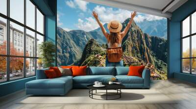 Back view of woman with backpack pulling her arms up against the background of the ancient city of Machu Picchu, summer vacation Wall mural