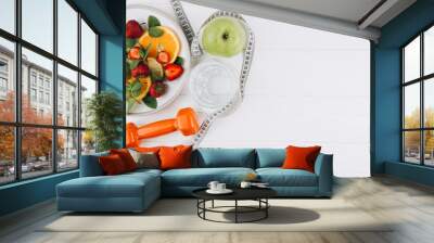 Diet plan, menu or program, tape measure, water, dumbbells and diet food of fresh fruits on white background, weight loss and detox concept, top view Wall mural