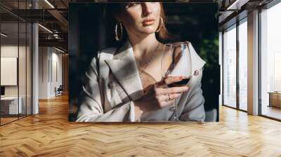 Elegant and glamour woman with glass of red wine in restaurant. Wall mural