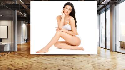 Fitness young woman with a beautiful body sitting on white background Wall mural