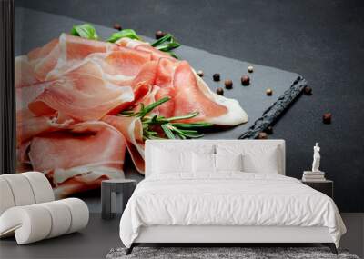 Italian prosciutto crudo or spanish jamon. Raw ham on stone cutting board Wall mural