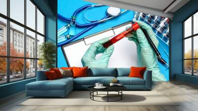 lab technician assistant or doctor holding a blood sample in test tube Wall mural