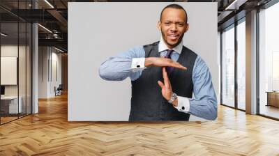 Young african american businessman showing a pause time out gesture with hands - body language signs symbols Wall mural