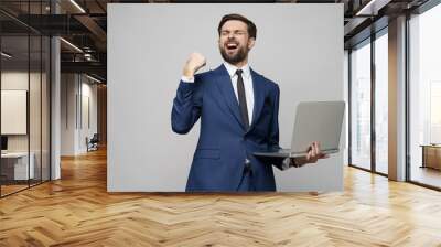 Young handsome businessman Holding a laptop Computer with Blank Screen Wall mural