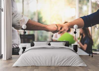 Close up images, the hand of Business men Fist bump with blurred of business women meeting at workplace, concept to business teamwork for success Wall mural