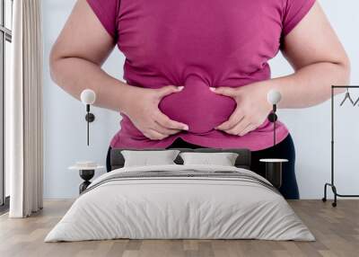 Fat women  Using two hands to hold the excess fat In the area of her waist, with white background to obesity and health care concept. Wall mural