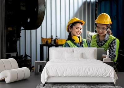 Portrait images of two Asian woman engineer are is using a notebook computer at workplace Which is an industrial factory, to working woman and technician concept. Wall mural