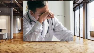 The doctor is stressed and tired from hard work to take care of patients, to health concept. Wall mural