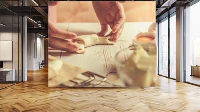 Baker making croissants on rustic wood background Wall mural