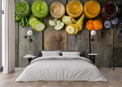 Colorful baby food purees in glass jars Wall mural