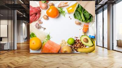 Grocery shopping concept. Balanced diet concept. Fresh foods with shopping bag on white background Wall mural