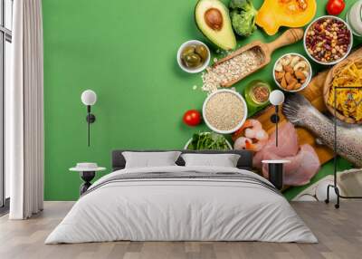 Mediterranean diet concept - meat, fish, fruits and vegetables on bright green background Wall mural