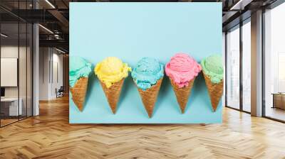 Pastel ice cream in waffle cones, bright background, copy space Wall mural