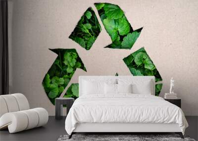 Recycling concept - recycling symbol made in cardboard with plastic, green grass in background Wall mural