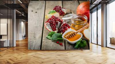 Rosh hashana jewish holiday concept - apples, honey, pomegranate, rustic wood background Wall mural