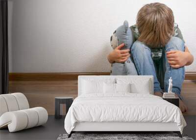 Sad depressed boy with teddy bear Wall mural