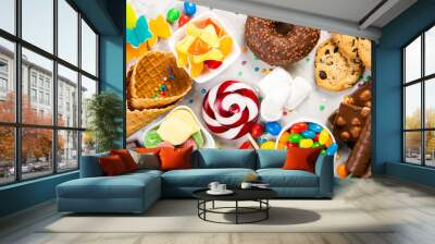 Selection of colorful sweets - chocolate, donuts, cookies, lollipops, ice cream top view Wall mural