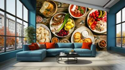 Selection of traditional ukrainian food - borsch, perogies, potato cakes, pickled vegetables, top view Wall mural