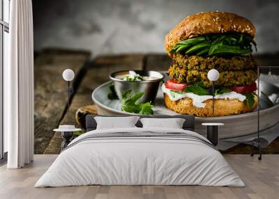 Vegan zucchini burger and ingredients on rustic wood background, copy space Wall mural