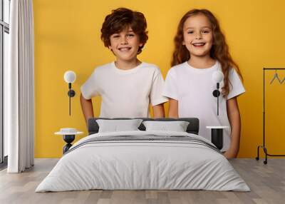 Male and female child, boy and girl, siblings wearing bella canvas white shirt mockup, at yellow background. Design tshirt template, print presentation mock-up. AI generated. Wall mural