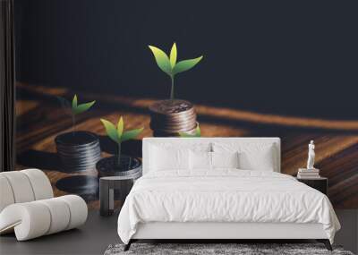 Tree growing on Stacks British money sterling pound coins on wooden table, GBP coins on the floor with shadow and light in dark room, Business and financial for money saving or investment concept Wall mural