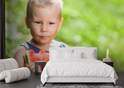 Cute toddler eating a slice of watermelon Wall mural