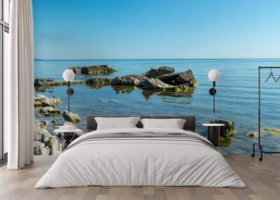 summer landscape with a rocky sea shore, remnants of an old concrete structure in the water, Saaremaa Island, Sorves Peninsula, Estonia Wall mural