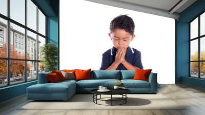 Latin boy praying with closed eyes, isolated on white background. Religious concept. Child praying. Wall mural