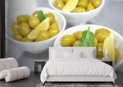 Whole green Greek olives in a white bowl. close up. vertical view of olives. Wall mural