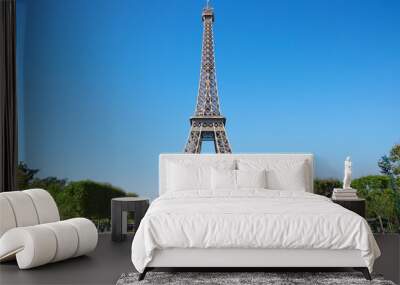 Eiffel tower, sunny summer day with blue sky and green Field of Mars Wall mural