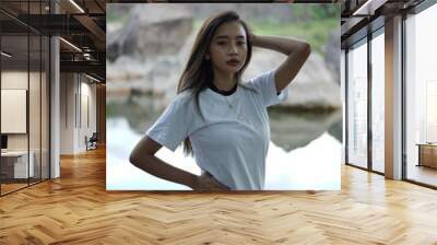 the stylish young woman wears a white short sleeve t-shirt with a view of the lake and rocks. black t-shirt models for mockups and templates. Wall mural