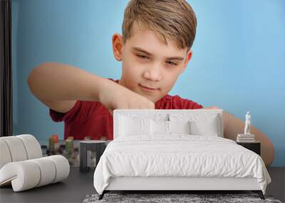 A boy controls a mixing console in a music studio. Wall mural